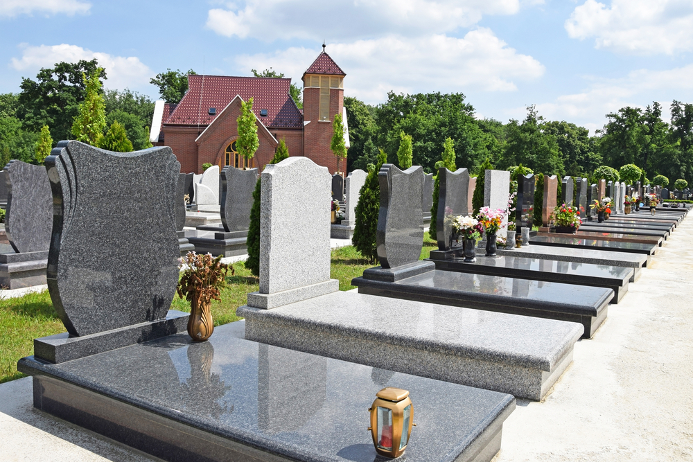 A row of black and white memorials lined up in a cemetary