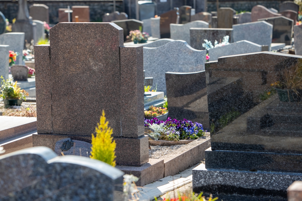 Numerous gravestones and memorials in a graveyard